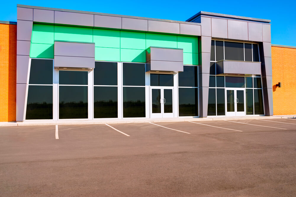 a green and orange exterior painting job on a commercial building